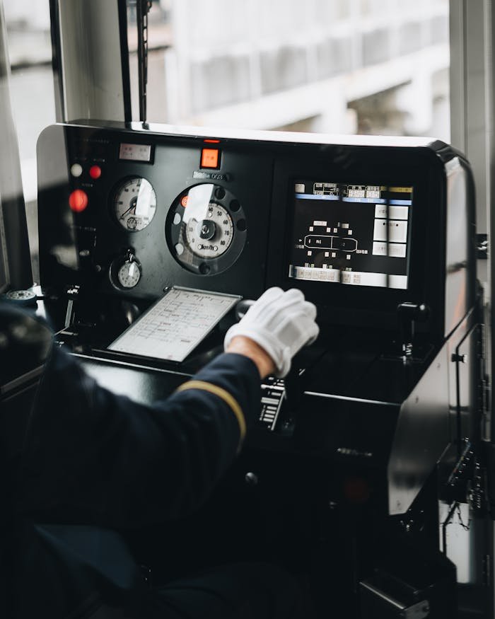 Close-up of a train operator's control panel inside a metro train cabin.